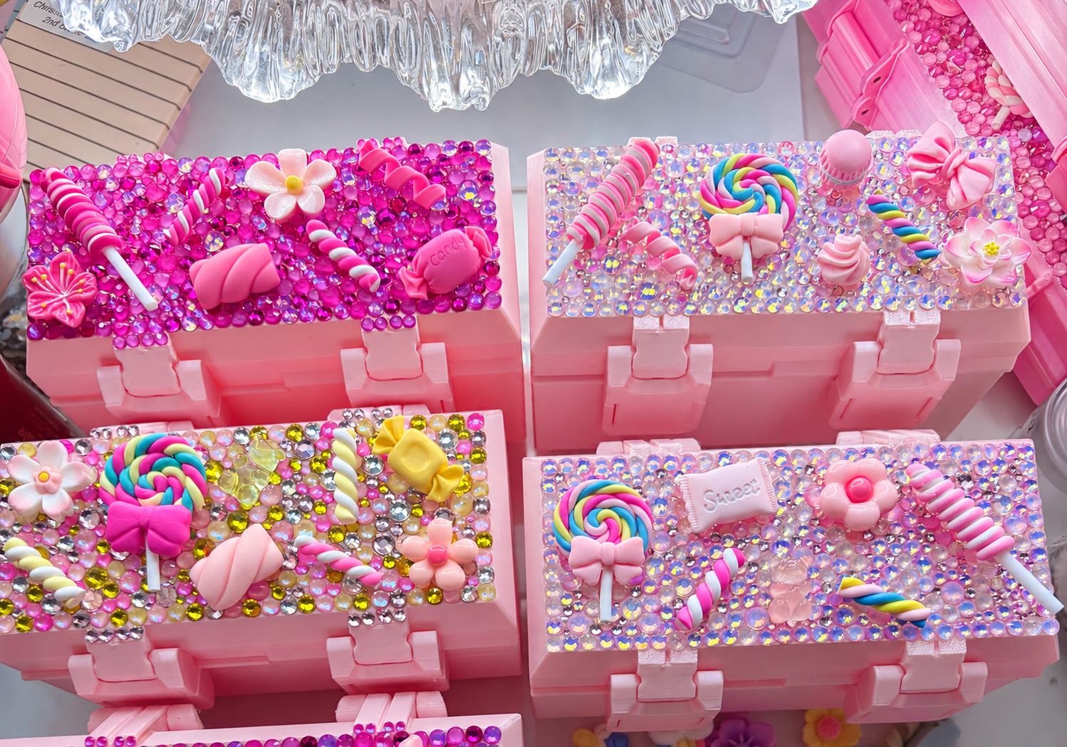 Pink rhinestone cases decorated with colorful candy charms and bows